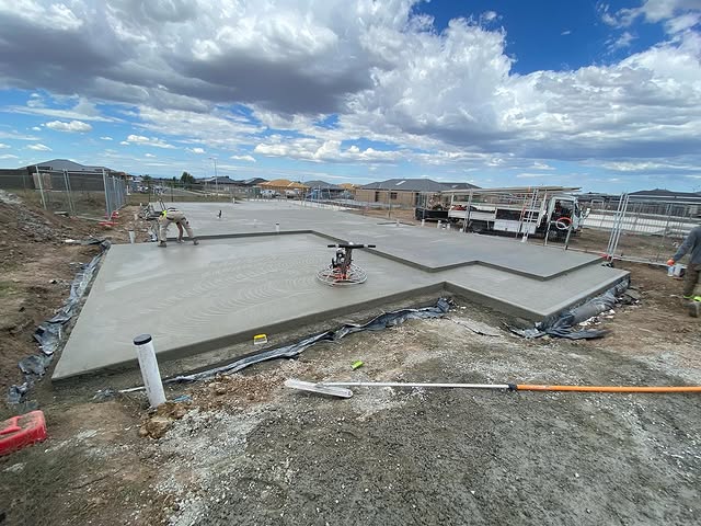 Power trowel finishing a fresh house slab on a new housing estate
