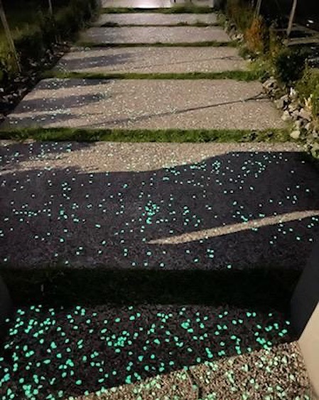 Exposed aggregate path and steps with glowing stones at night