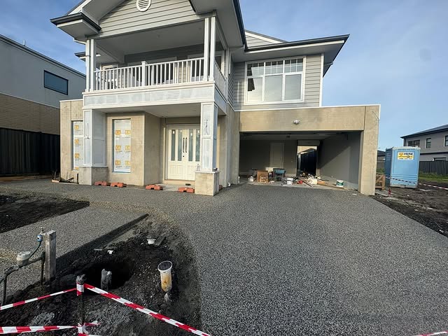 Crushed rock driveway base laid in front of a new two-storey home
