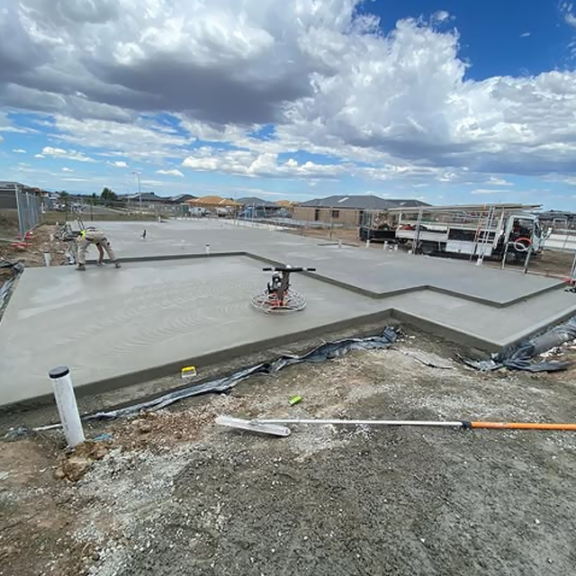 Power trowel finishing a fresh house slab on a new housing estate