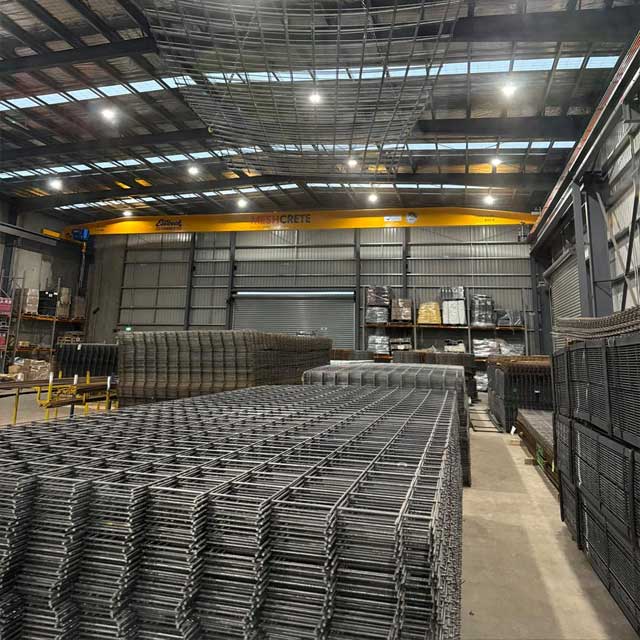 Stacks of steel reinforcing mesh inside a large warehouse